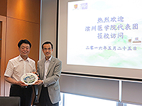 Prof. Dennis Ng (right), Associate Vice-President and University Dean of Students of CUHK, presents a souvenir to Mr Li Kexiang, Deputy Director of Binzhou Medical University
